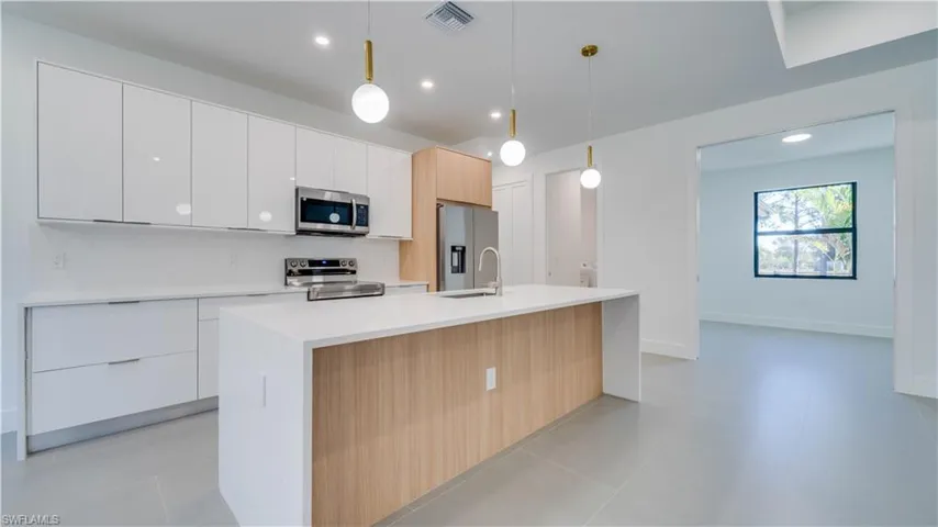 Kitchen with den in background.
