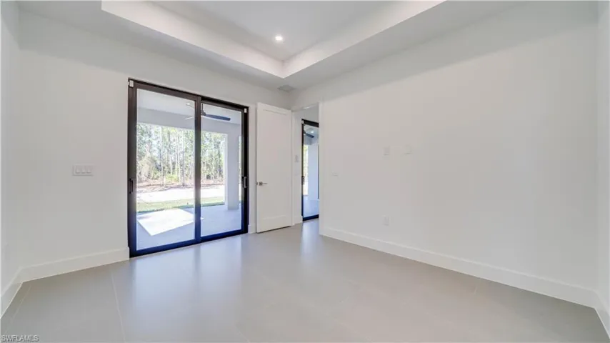 8' high sliders out to the lanai and a 10' high tray ceiling with recessed lighting.