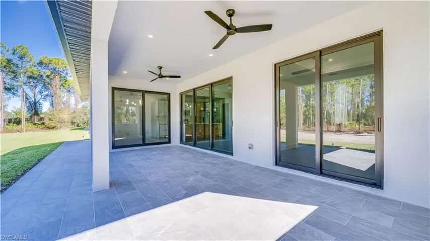 Large open lanai with beautiful tile, recessed lighting, and ceiling fans.