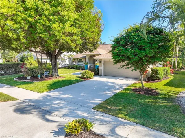 View of front of home featuring a garage and a front lawn
