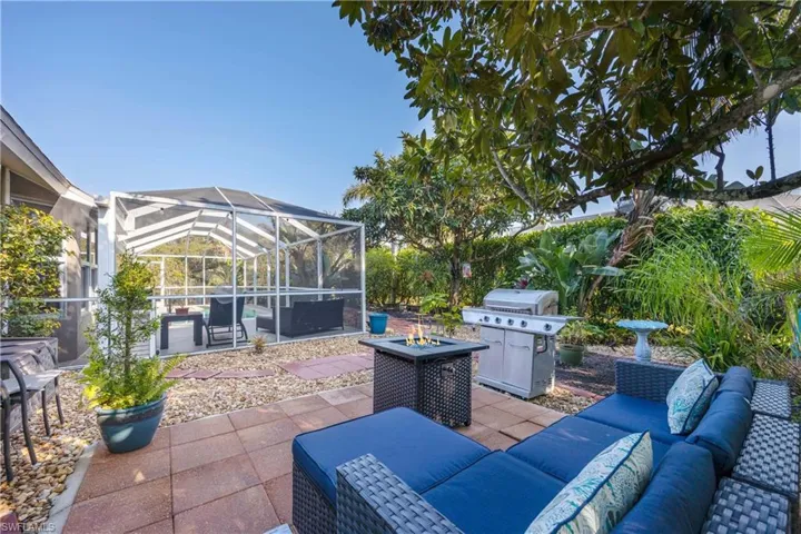 View of patio / terrace featuring an outdoor living space with a fire pit, a lanai, and area for grilling