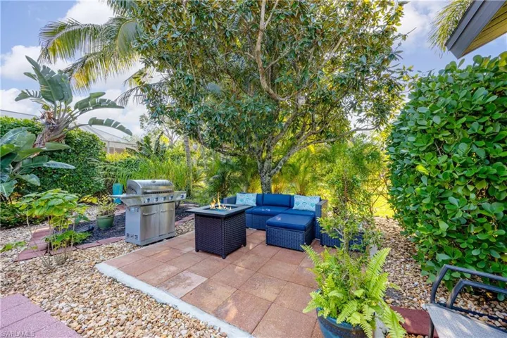 View of patio / terrace featuring an outdoor living space with a fire pit and grilling area