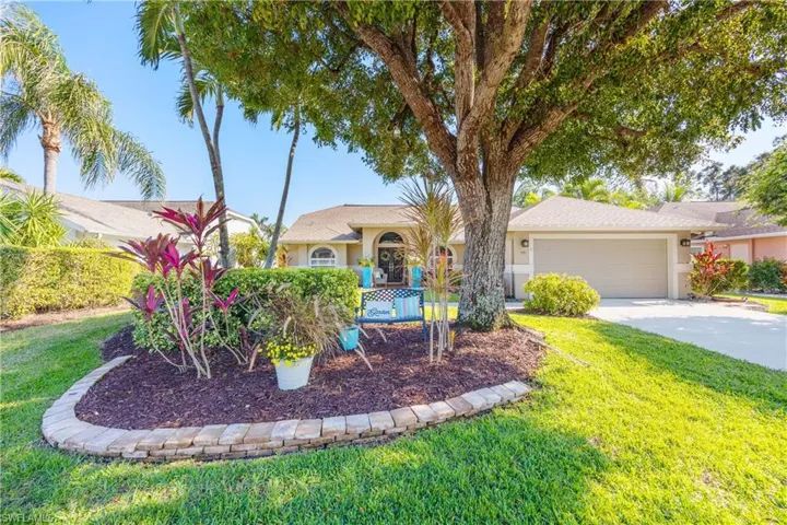 View of front of house featuring a front lawn and a garage