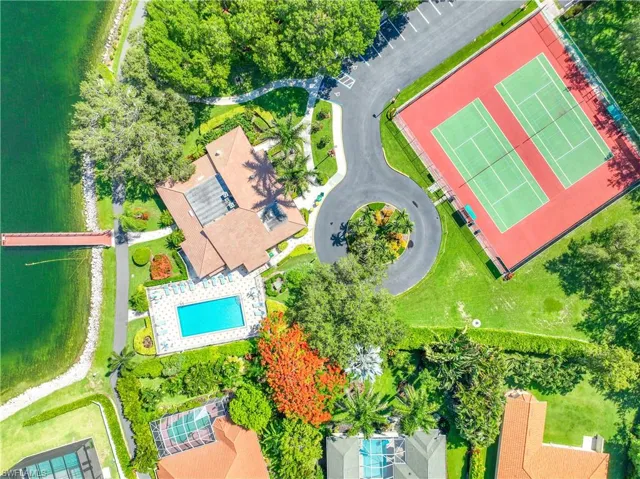 Birds eye view of property with a water view
