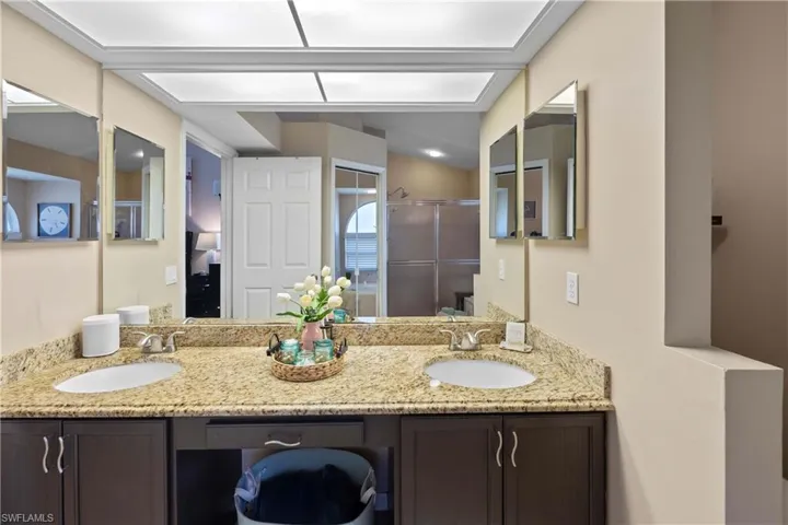 Bathroom featuring walk in shower and vanity