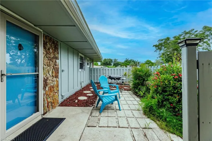 View of patio with a grill
