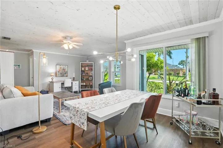 Kitchen featuring appliances with stainless steel finishes, crown molding, decorative backsplash, dark wood-type flooring, and wood ceiling