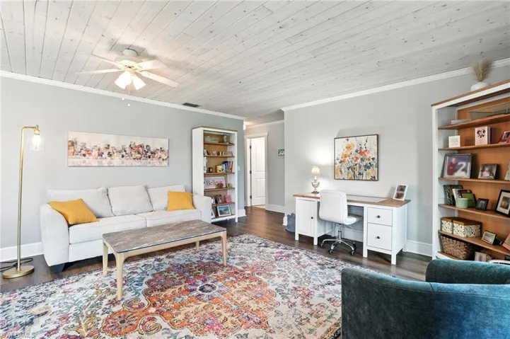 Living area with crown molding, wooden ceiling, a ceiling fan, wood finished floors, and a chandelier