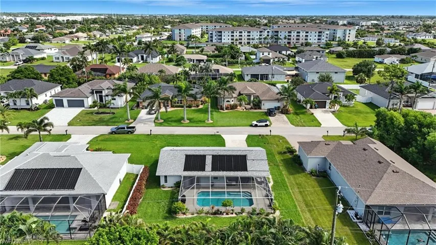 Aerial perspective of suburban area with a pool area