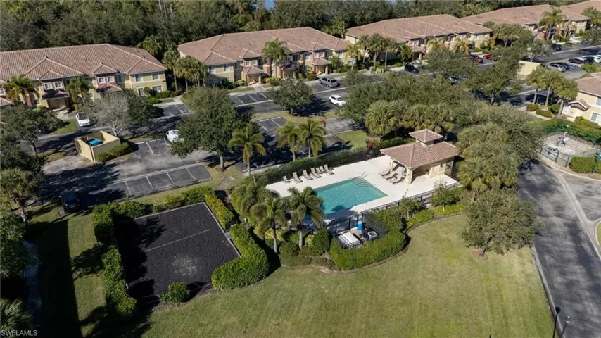 Aerial view of property and surrounding area with nearby suburban area
