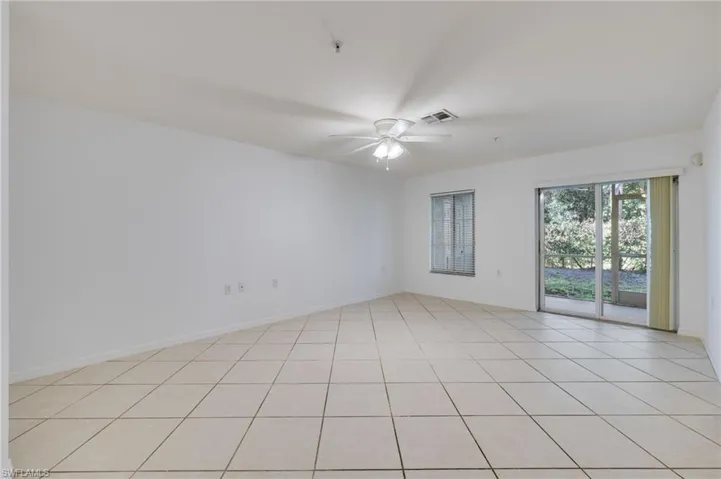 Spare room featuring a ceiling fan and light tile patterned flooring