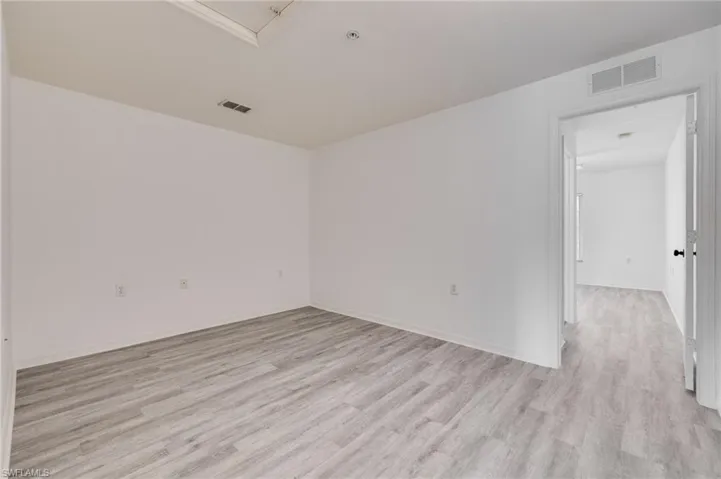 Spare room featuring light wood finished floors and baseboards