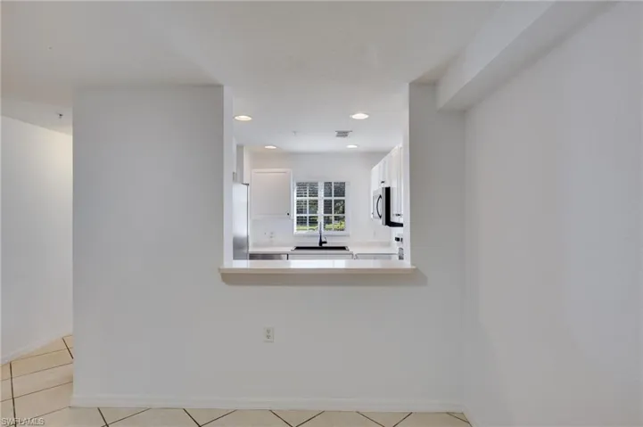 Empty room with recessed lighting and light tile patterned flooring