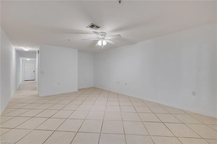 Unfurnished room with a ceiling fan and light tile patterned floors