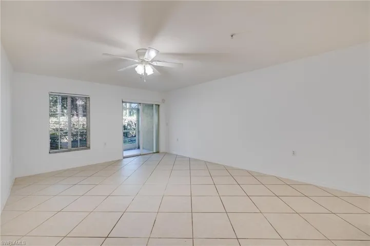 Empty room featuring a ceiling fan and light tile patterned flooring