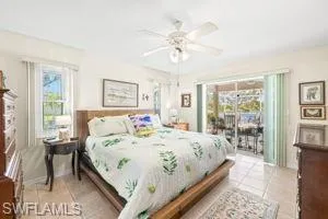 Bedroom featuring ceiling fan, access to outside, and light tile patterned floors