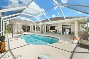Pool featuring glass enclosure and a patio area