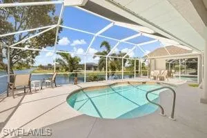 Outdoor pool with a patio and a lanai