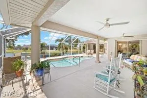 Pool featuring a lanai, ceiling fan, and a patio area