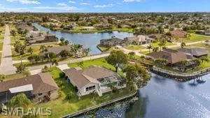 Birds eye view of property with a residential view and a water view