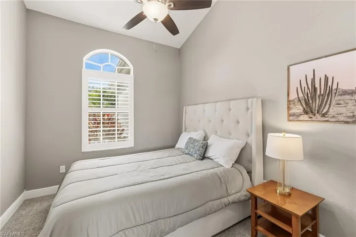 Bedroom featuring carpet flooring, a ceiling fan, and vaulted ceiling