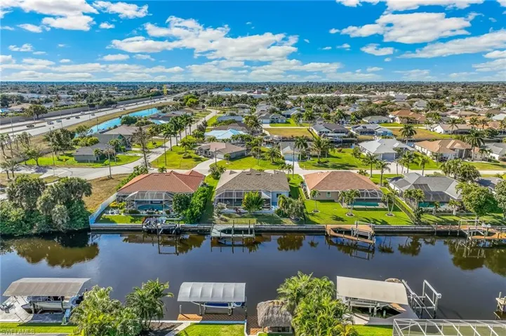 Aerial perspective of suburban area with a nearby body of water