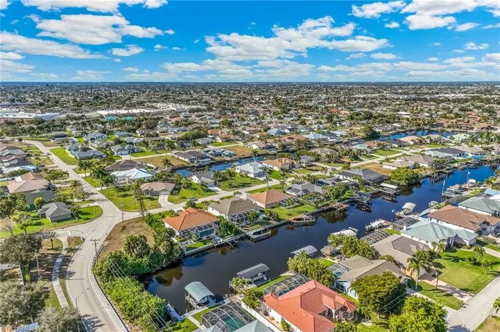 Aerial perspective of suburban area featuring a large body of water