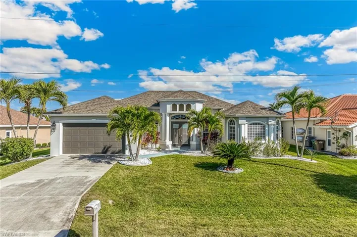 Mediterranean / spanish-style home with stucco siding, concrete driveway, a front lawn, and an attached garage