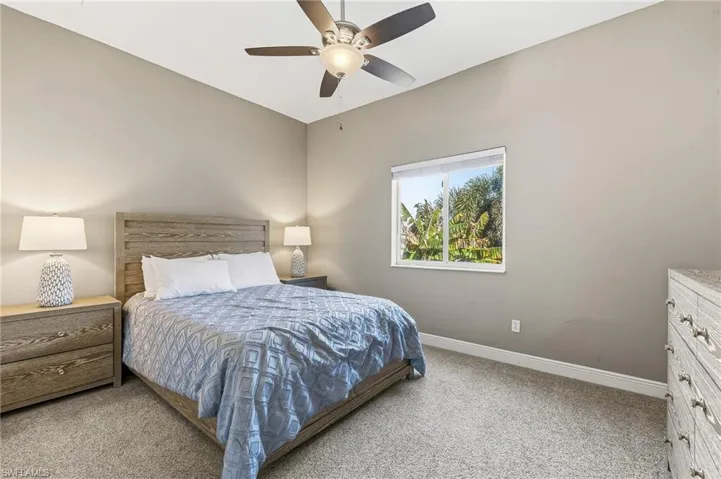 Bedroom with light colored carpet and ceiling fan