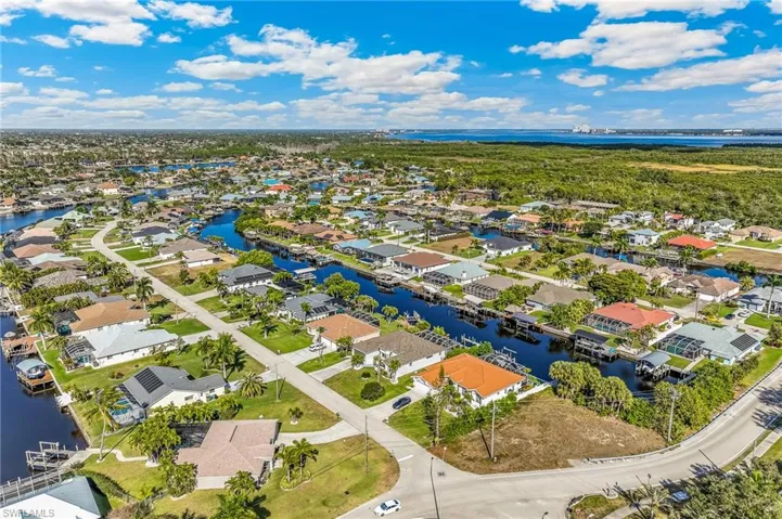 Aerial view of residential area featuring a nearby body of water