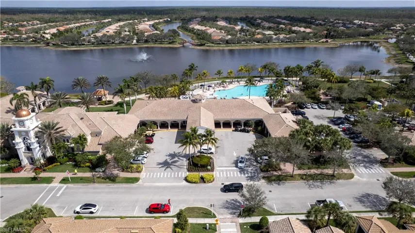 Drone / aerial view of a pool and a nearby body of water