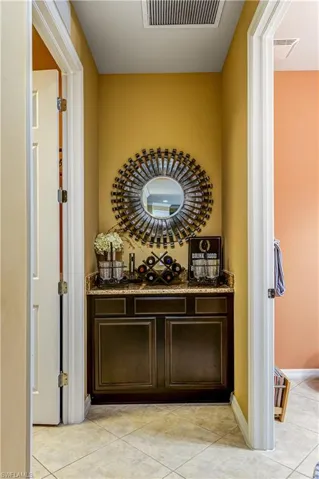 Wine cellar featuring light tile patterned flooring and baseboards