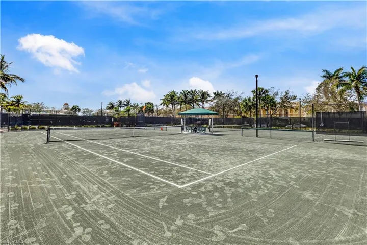 View of tennis court featuring community basketball court