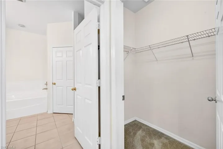 Spacious closet featuring light tile patterned floors