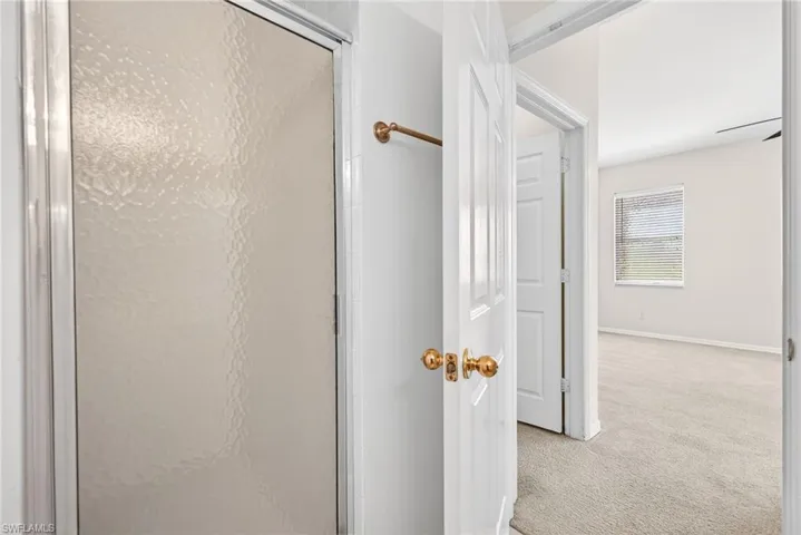 Full bathroom featuring carpet and a stall shower