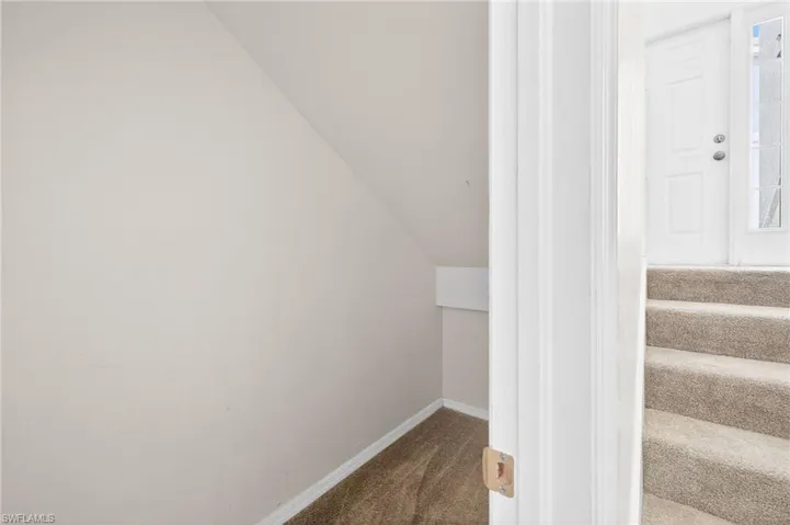Stairway with carpet flooring and baseboards
