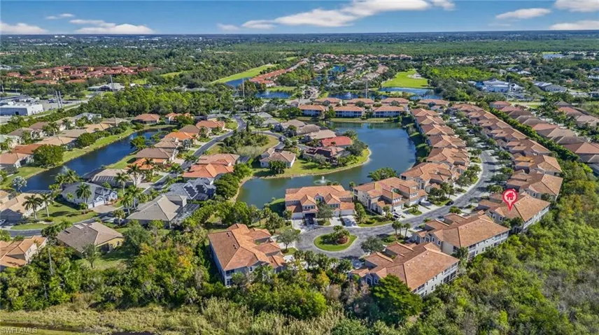 View of property location featuring a nearby body of water and nearby suburban area