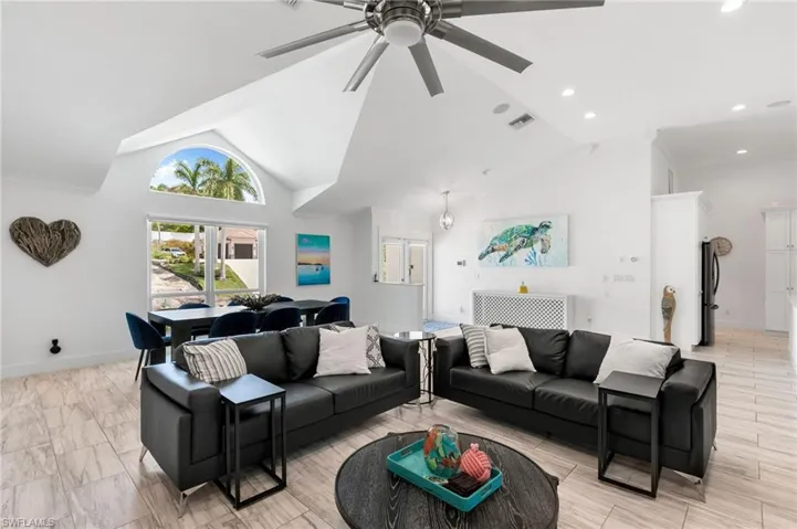 Living room with high vaulted ceiling and ceiling fan
