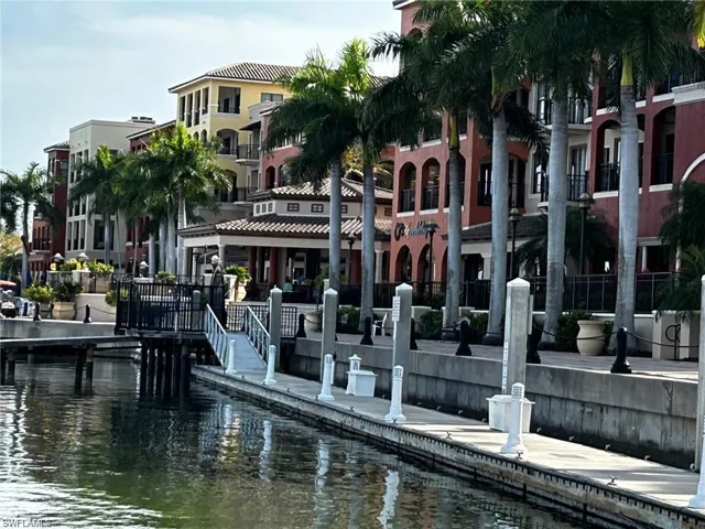 View of dock with a balcony and a water view