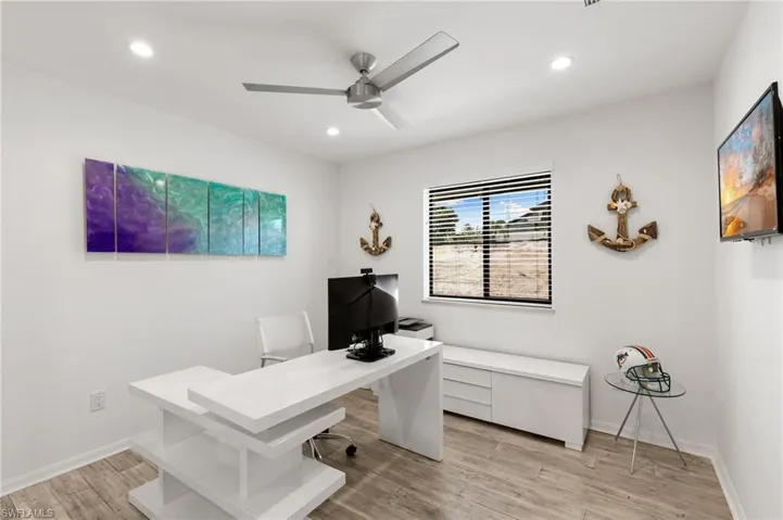 Office space featuring light hardwood / wood-style flooring and ceiling fan