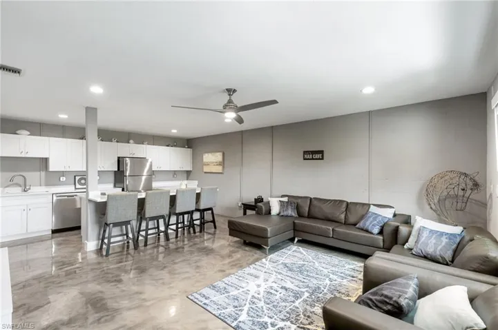 Living room featuring sink and ceiling fan