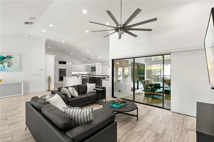 Living room featuring lofted ceiling and ceiling fan