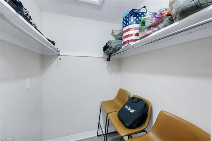 Compact interior space featuring white painted walls and built-in shelving