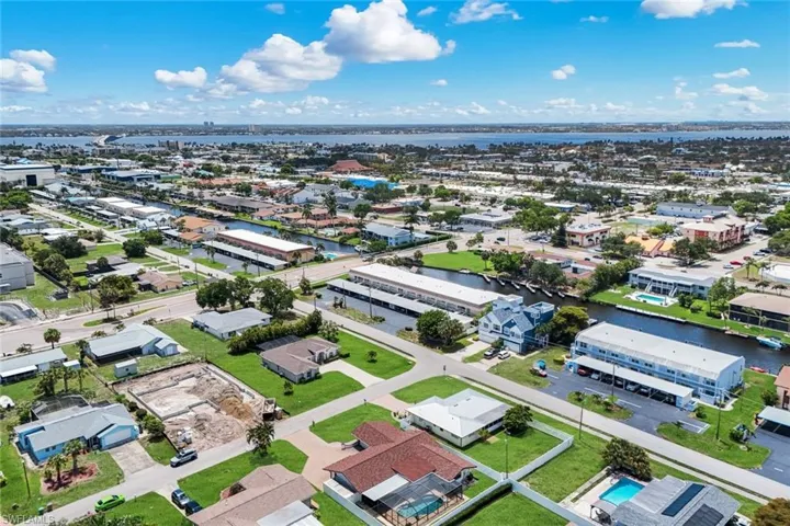 Aerial perspective showcasing a canal-front community with waterway access