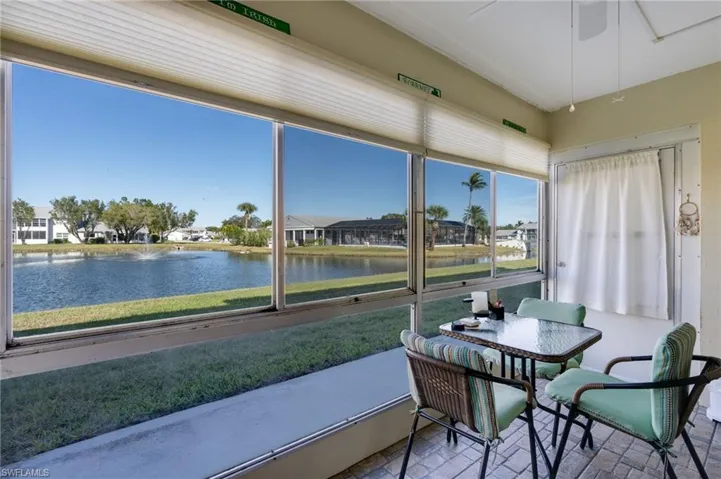 Sunroom / solarium featuring a water view