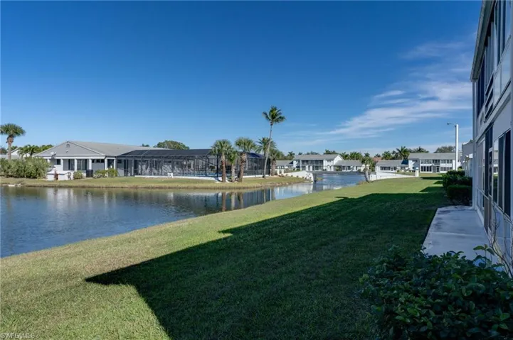View of grassy yard with a water view fromy your patio door
