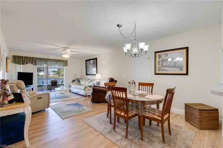 Dining room with a ceiling fan with lights.