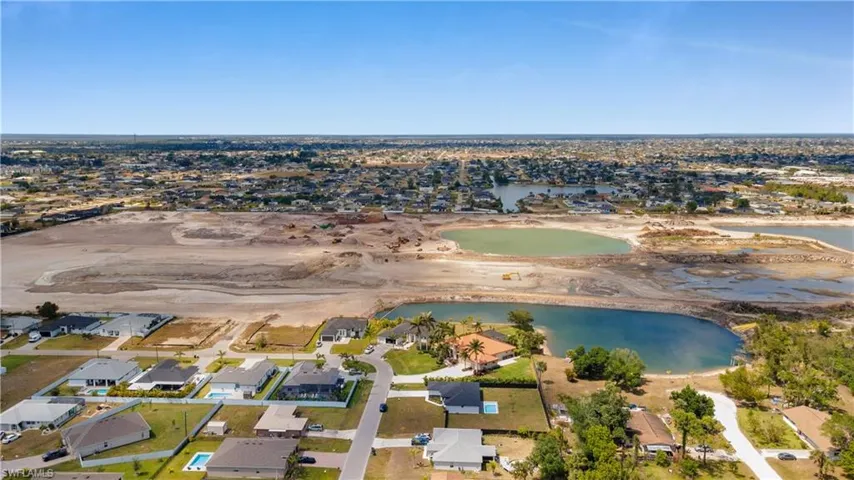 Drone / aerial view with a residential view and a water view