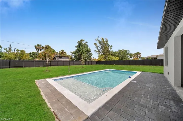 View of swimming pool with a fenced in pool, a fenced backyard, a yard, and a patio area