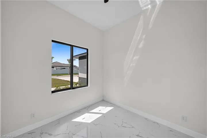 Empty room with baseboards and marble finish floor